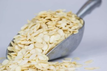 Blanched sliced almonds in a silver scoop