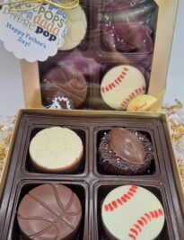 Four chocolate covered oreos decorated in sports themes and ready to gift