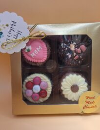 Four decorated chocolate covered Oreos® in a gift box