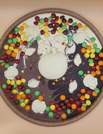 Chocolate Pizza with colorful milk chocolate gems and chocolate decorations