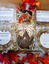 Savor the Flavors of Fall Gift Basket featuring gourmet autumn chocolates, white chocolate pretzels, freshly roasted colossal cashews, 19th Hole Snack Mix, and a handmade milk chocolate pumpkin.