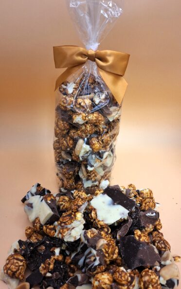 Nutty Caramel Chocolate Popcorn in a clear bag with a bow.
