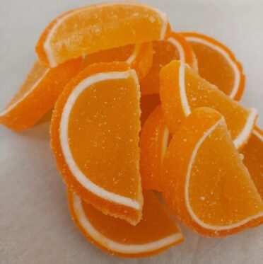 Orange in color large jelly slices with white rind