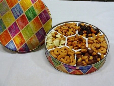 gift tin filled with chocolate covered, roasted and butter toffee cashews